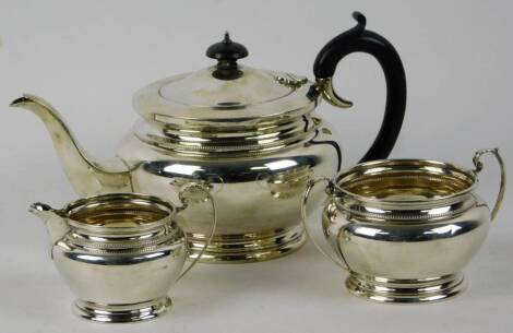 A three piece silver tea service, of modern circular form, Birmingham 1952.