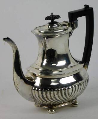 A George V silver part fluted coffee pot, of baluster form, raised on bun feet, Sheffield 1923, 26.73oz. gross