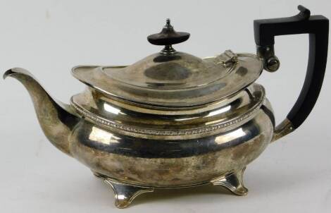 A George V silver teapot, by Elkington & Co. of squat baluster form, with ebonised handle and knop finial on splayed feet, Birmingham 1919, 25oz, 15cm H.