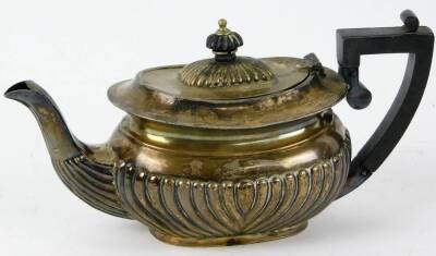 An Edwardian silver small teapot, of squat rectangular form with ebonised knop and handle, Birmingham 1902, 10½oz all in.