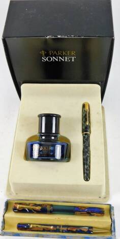 A Parker Sonnet boxed pen and ink set, the pen in black and grey decoration with gilt coloured clip and trim, 13cm W, and a cased vacuum filling fountain pen and pencil set. (2)