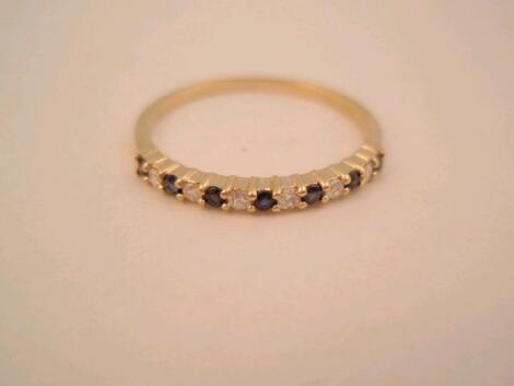 An 18ct sapphire and diamond half eternity ring