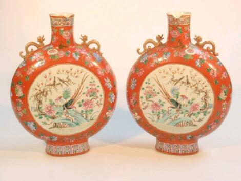 A pair of Chinese Moon Flasks painted in famille rose enamels with fantastic