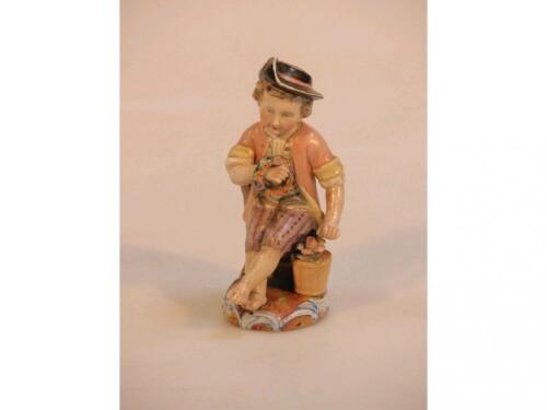 A 19thC German porcelain figure of a young boy