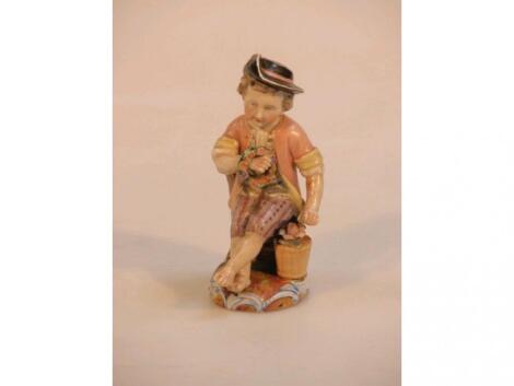 A 19thC German porcelain figure of a young boy