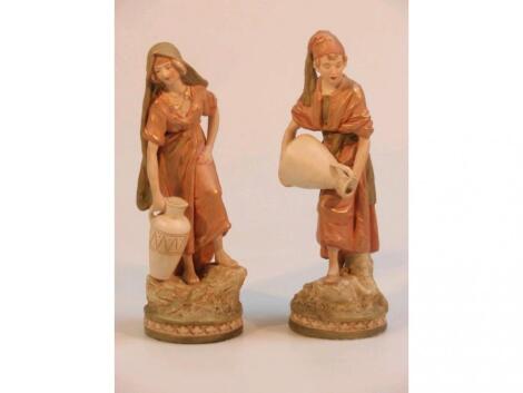 A pair of Royal Dux figures of water carriers