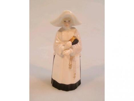 A Royal Worcester bone china candle snuffer modelled as a Mother Superior