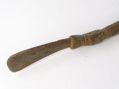 A Papua New Guinea tribal paddle, with leaf shaped blade, tapering handle with carved finial, bearing label stating Aborigine boat paddles, brought to England 1910, 153cm L. - 2