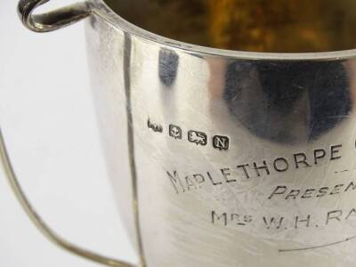 A George VI silver two handled cup, enamel with the crest of Lincoln engraved Lincoln Chrysanthemum Fruit and Vegetable show (L.G.A), on the reverse Mablethorpe Challenge cup, presented by Mrs W H Rawlinson, Birmingham 1937, 4¾oz excluding base. - 2