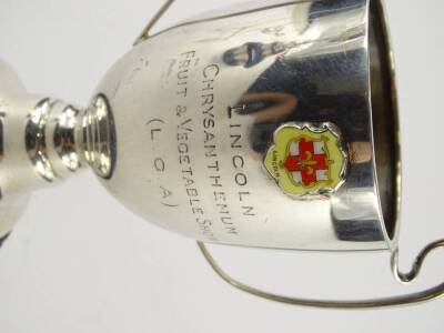 A George VI silver two handled cup, enamel with the crest of Lincoln engraved Lincoln Chrysanthemum Fruit and Vegetable show (L.G.A), on the reverse Mablethorpe Challenge cup, presented by Mrs W H Rawlinson, Birmingham 1937, 4¾oz excluding base. - 3