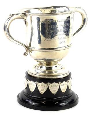 A George VI two handled silver cup, engraved Lincolnshire Gardeners Association The Parker Challenge Cup presented by Alderman C.T Parker CBE, JP 1938, Birmingham 1937, with iron screw attached, 14oz gross, on a black Bakelite base engraved with various n