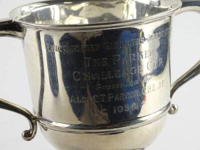 A George VI two handled silver cup, engraved Lincolnshire Gardeners Association The Parker Challenge Cup presented by Alderman C.T Parker CBE, JP 1938, Birmingham 1937, with iron screw attached, 14oz gross, on a black Bakelite base engraved with various n - 3