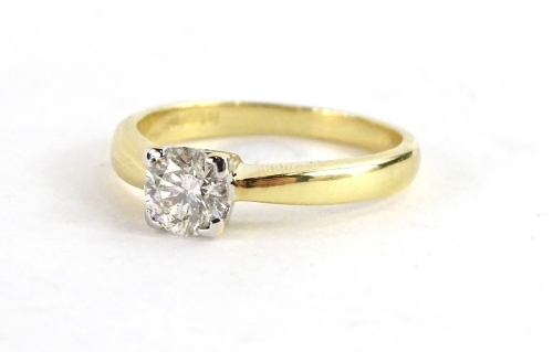 An 18ct gold diamond solitaire ring, with round brilliant cut diamond in four point platinum setting, the diamond approx 0.47cts, set in platinum on a plain gold band, maker D.J., ring size K½, 3.2g all in.