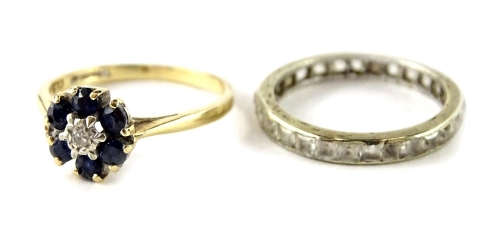 Two dress rings, to include a 9ct gold cluster ring, with blue and white stones, and a silver plated eternity ring. (2)