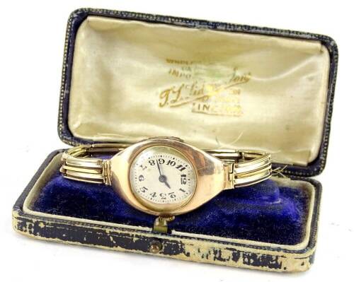 A wristwatch, with elongated diamond shaped watch head surround, with circular oval dial, with blue hands, with two row bracelet, all yellow metal, unmarked, 25.2g all in, in Lincoln box.