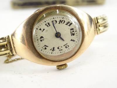 A wristwatch, with elongated diamond shaped watch head surround, with circular oval dial, with blue hands, with two row bracelet, all yellow metal, unmarked, 25.2g all in, in Lincoln box. - 2