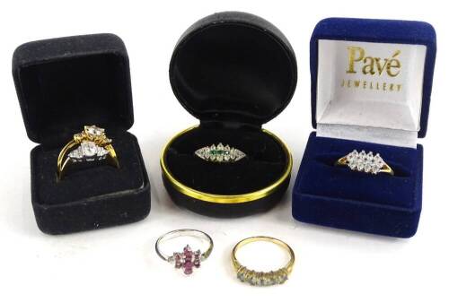 Six various gem set rings, to include a silver cluster ring, and five imitation gold dress rings, each of varying design, with four boxes.