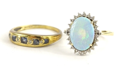 Two dress rings, to include an opal and diamond ring, with oval cut opal surrounded by tiny diamonds, yellow metal, marked 585, ring size Q, 3.6g all in, and a 9ct gold half hoop eternity ring, set with blue stones and diamonds, ring size S, 2.3g all in.