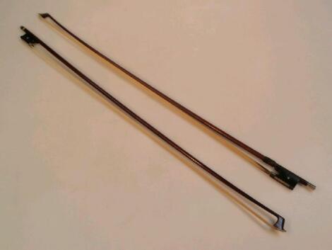 A violin bow, marked Vuillaume Nach, 74cm long, together with another bow, 74?cm long