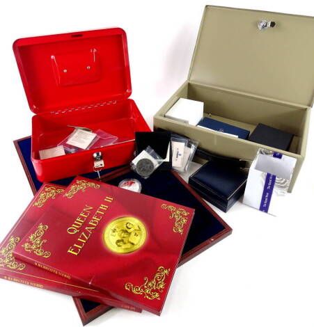 Thirteen Queen Elizabeth II gold coloured commemorative coins, with paperwork, other commemorative coins, a modern pocket watch and chain, two cash boxes etc.