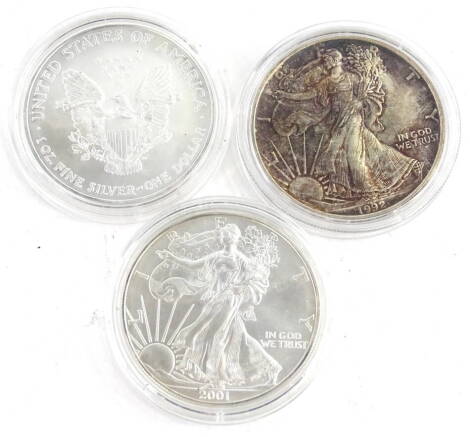 Three United States silver dollars, comprising 2006, 1992 and 2001.