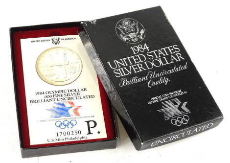 A 1984 United States silver dollar, in original packaging.