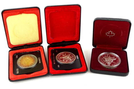 A selection of Canadian coins, comprising an 1882-1982 Canada dollar, a 1972 Canada silver dollar and a 1971 British Columbia Canada silver dollar.