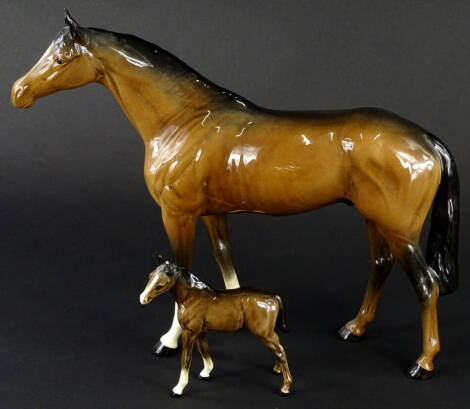 A Beswick ceramic model of a brown horse, with two white socks to the front, 28cm H and a similar foal (foal AF).