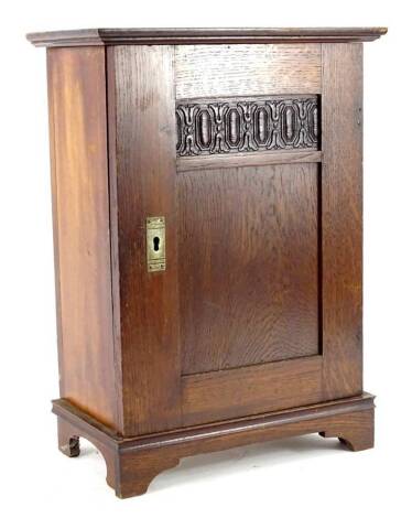 A late 19th/early 20thC smokers type cabinet, with panelled door enclosing a partially fitted interior with drawer.