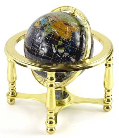 A modern table globe, inlaid in coloured stone etc., on brassed stand, 22cm dia.