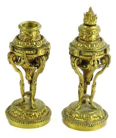 A pair of late 19thC French gilt metal cassolettes, each cast with flame finial, scrolls, swags etc., on three feet with domed plinth, 20cm H overall.