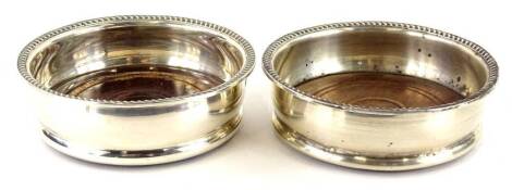 A pair of Elizabeth II silver and mahogany coasters, each with a gadroon border, Birmingham 1977, 10cm Dia.