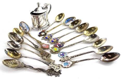 An Elizabeth II oval silver mustard pot, with blue glass liner on bun feet, Sheffield 1952, and various white metal and other souvenir spoons, to include enamelled pieces.