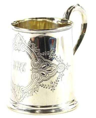 A Victorian silver Christening mug, the elaborate engraved cartouche bearing initials, with a scroll handle, London 1872, 4¼oz, 9.5cm H.