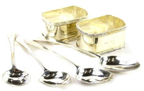 A set of four 19thC silver Old English pattern teaspoons, and a pair of silver plated napkin rings.