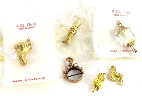 Six various 9ct gold charms, to include lantern, boot, fish, imp, fish, and a swivel fob, lacking stone, 15g all in.