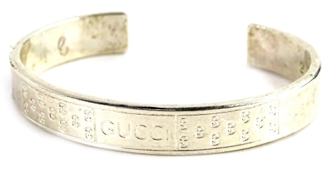 A silver Gucci torc bangle, with GG and Gucci design centre.