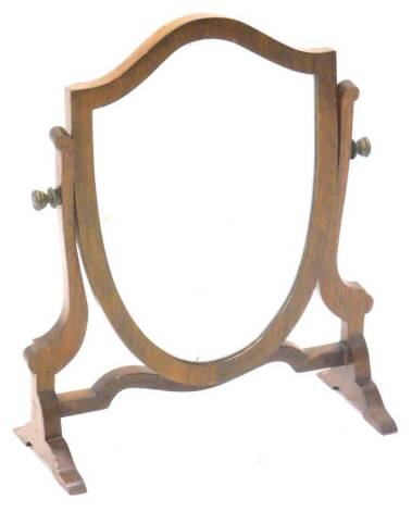 A small mahogany shield shaped dressing table mirror, on shaped supports, 32cm W.