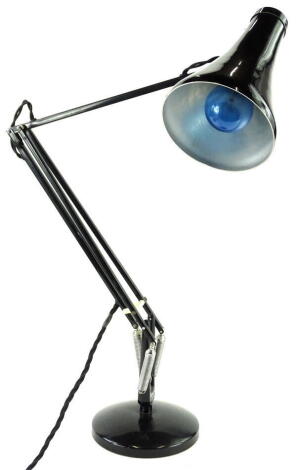 A black painted anglepoise type lamp, with a weighted base.