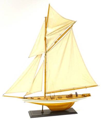 A pond yacht, with single mast and linen sale, on a wooden stand, 80cm W.