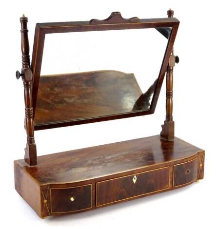 A 19thC mahogany tulipwood and boxwood strung dressing table mirror, the rectangular plate on turned supports, the bow fronted base, with three drawers on small bone feet, 53cm W.