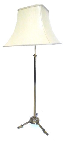 An Edwardian adjustable brass floor lamp, on tripod base, adapted from an oil lamp, 151cm H.