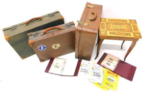 A simulated crocodile skin brown leather dressing case, two further suitcases with leather mounts and an Italian musical work table. (4)