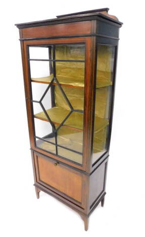 An Edwardian mahogany and boxwood strung display cabinet, with single glazed door, above a four front music compartment on square tapering legs, 63cm W.