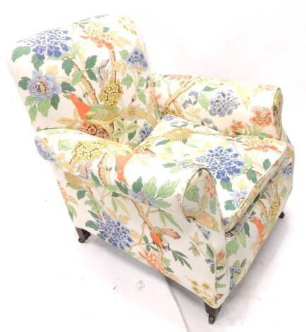 An Edwardian mahogany armchair, upholstered in floral fabric on square tapering legs.