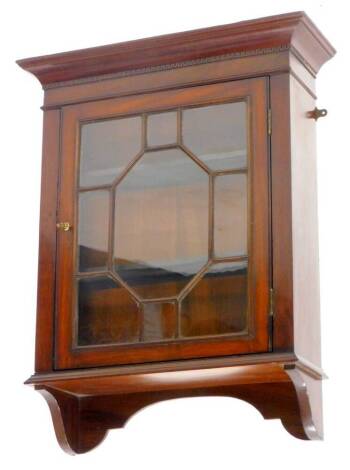 An Edwardian mahogany wall cabinet, with a moulded cornice above a single astragal glaze door, 60cm W.