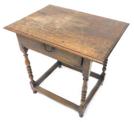 A late 18th/early 19thC oak side table, the rectangular planked top with a moulded edge above a frieze drawer on turned supports with plain stretchers, 72cm W.