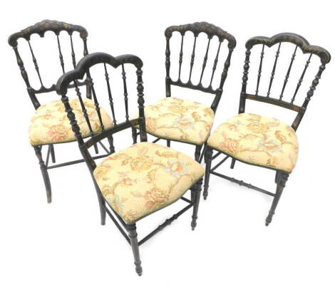 A set of four ebonised and gilt Victorian side chairs, each with spindle turned back and a padded seat on turned splayed legs. (AF)