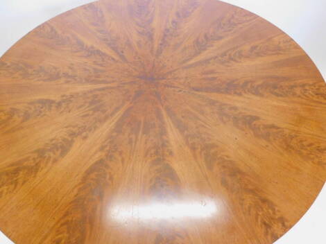 A mahogany dining table, the circular top with radiating veneers, on plain feet, adapted, 132cm dia.