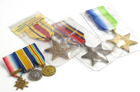 A set of World War I miniatures, comprising the 1914 star, the 1914-1918 Victory medal and the defence medal, and three other full size World War I style medals.